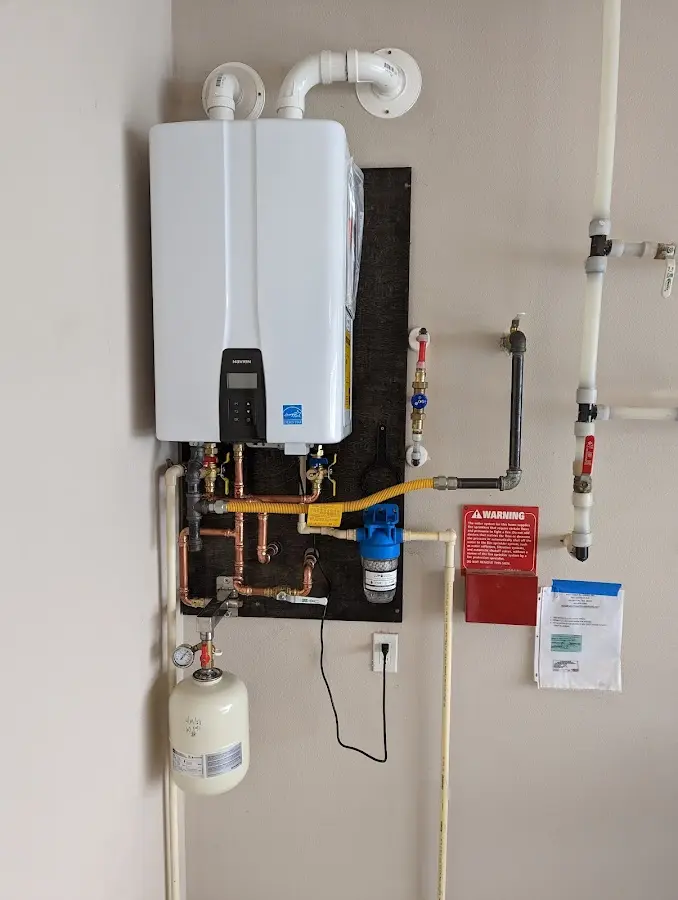 Professional plumber installing copper piping in a Barre home